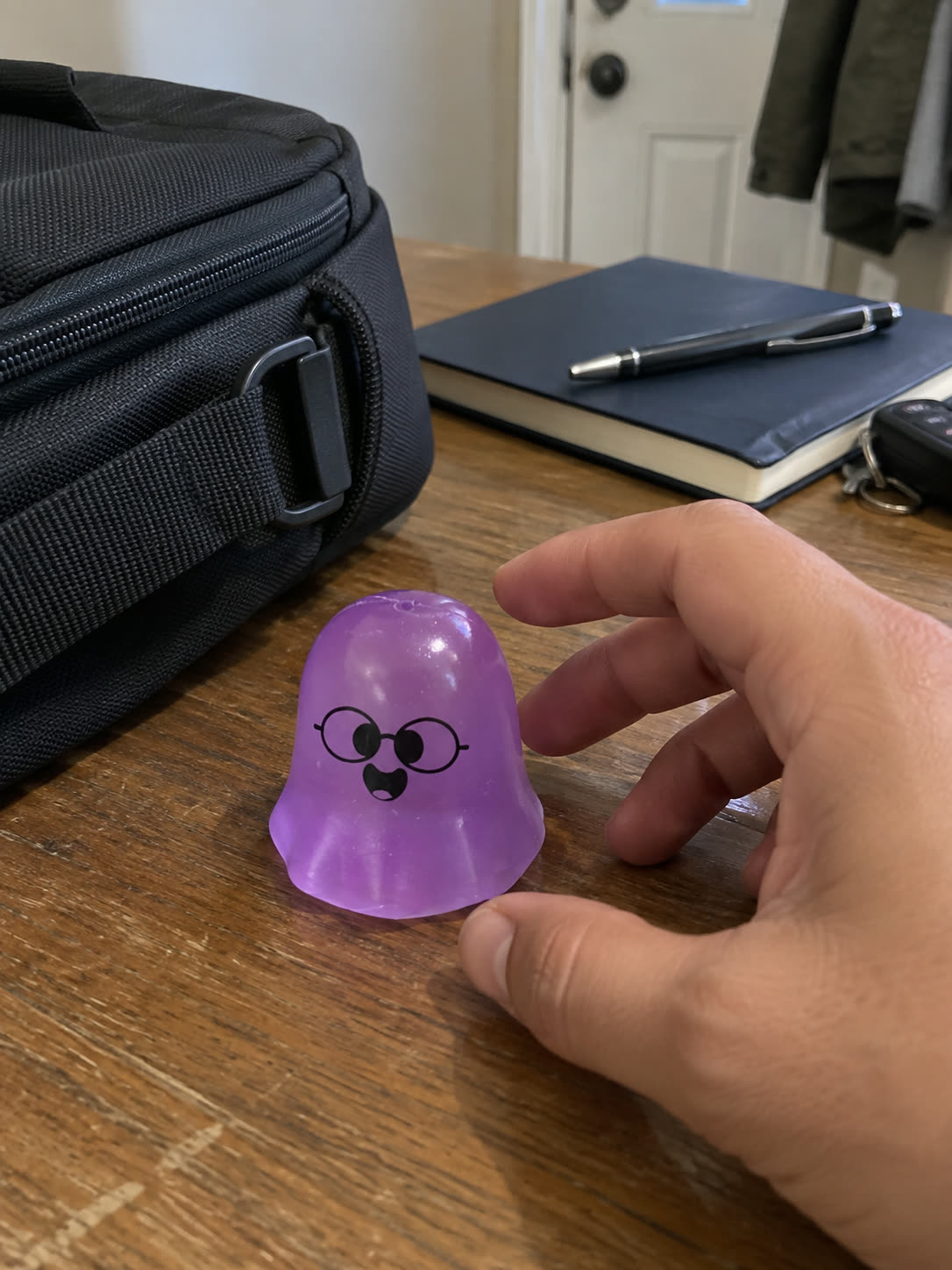 Customer review scene showing the ghost toy near office and bag items