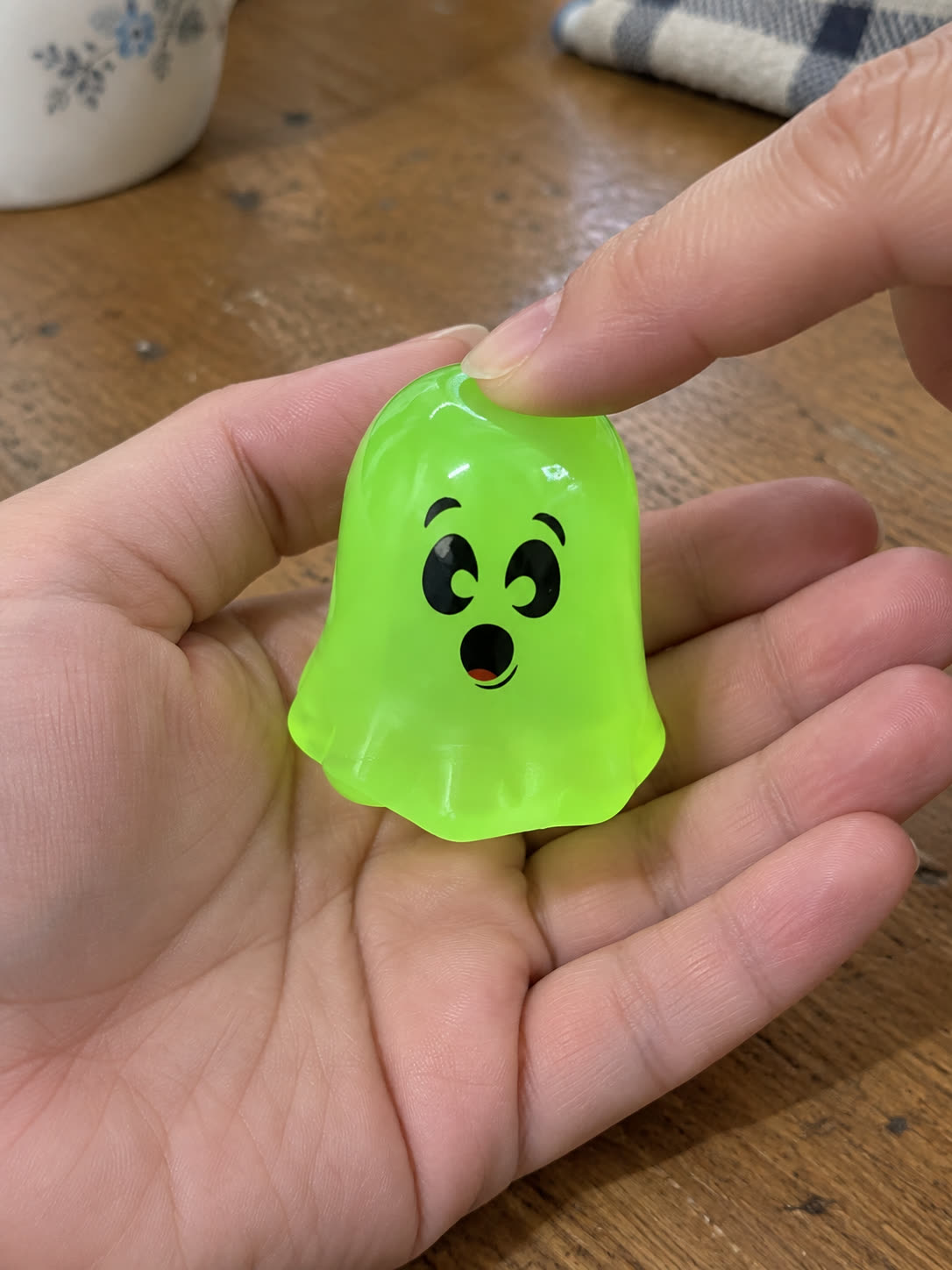 Customer review scene showing the ghost toy being gently pressed