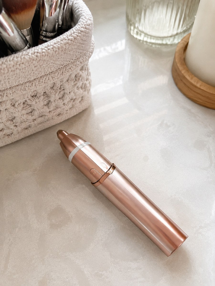 Rose gold Dluvivo trimmer on a bathroom vanity