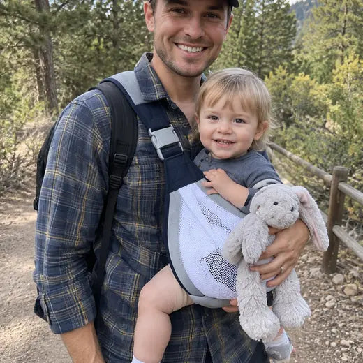 Father wearing the baby sling carrier on an outdoor trail