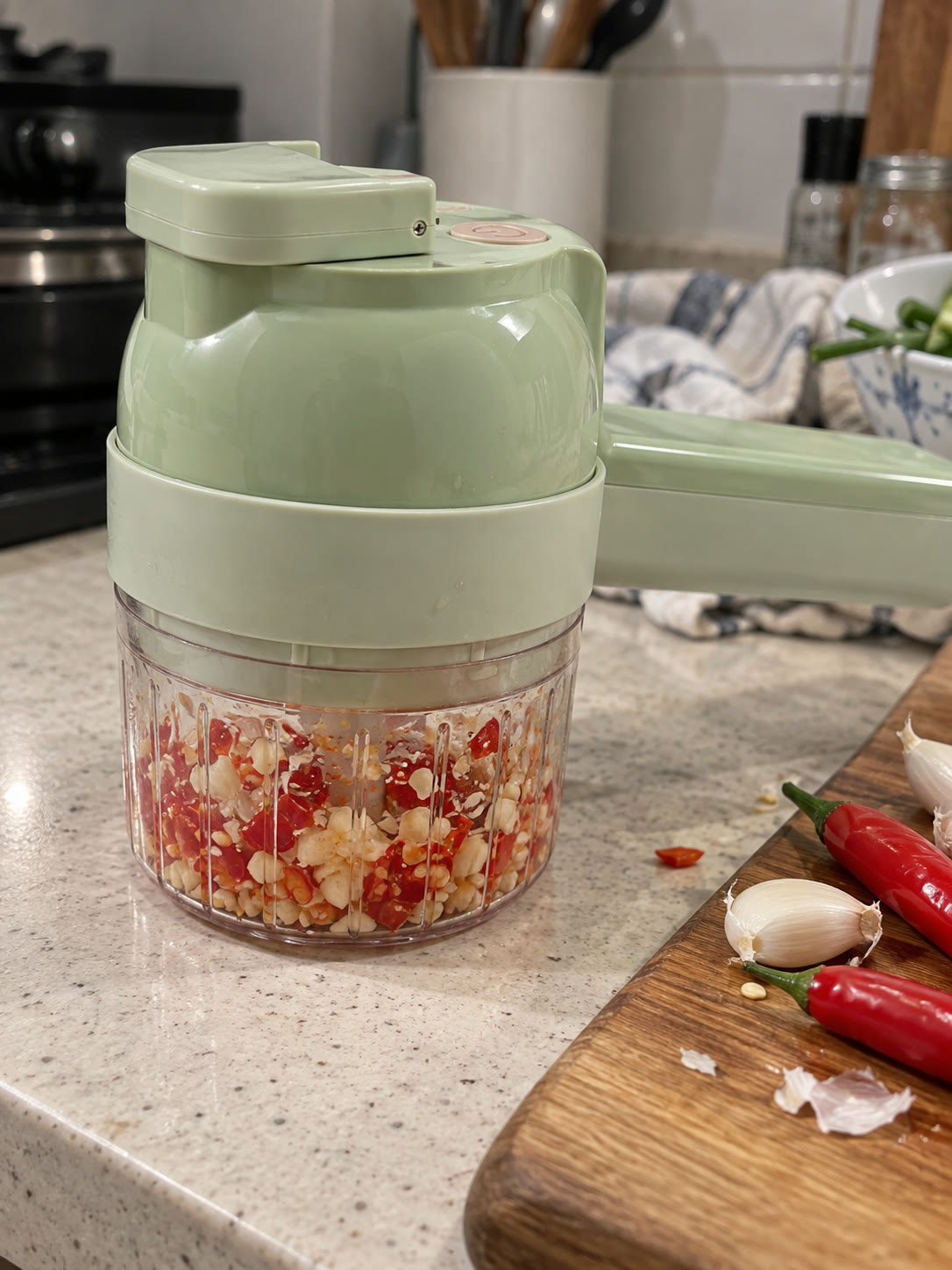Garlic and chili pieces visible through the clear chopping cup