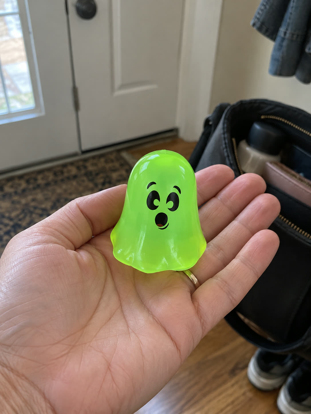Customer review scene showing the small ghost toy carried in a hand near a bag
