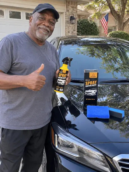 Customer giving thumbs up with car coating spray on a black car