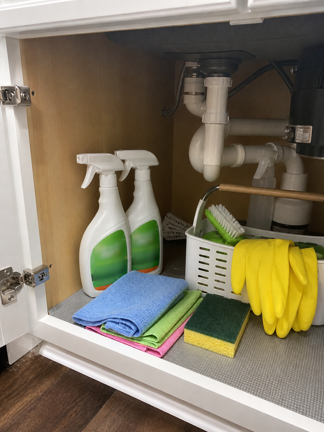 Customer photo showing two cleaner bottles stored under the sink