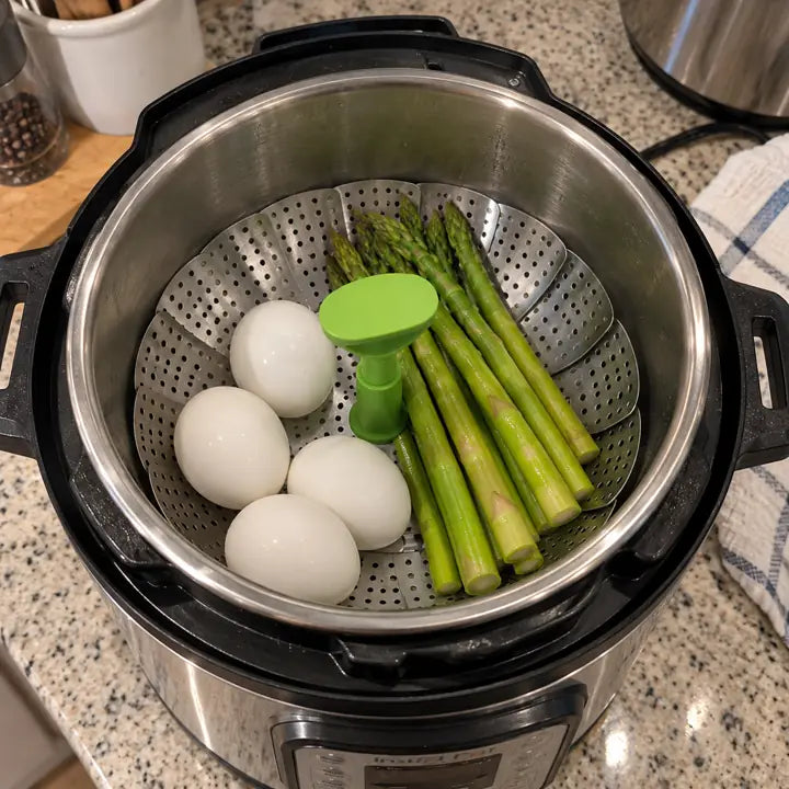 Customer steaming eggs and asparagus in electric cooker