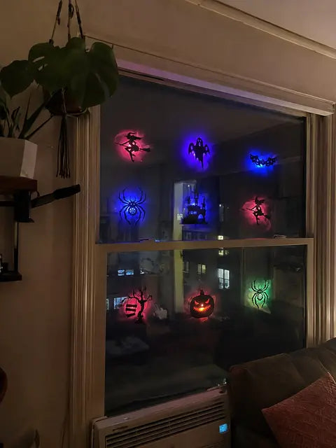 Customer window display with glowing Halloween silhouette lights