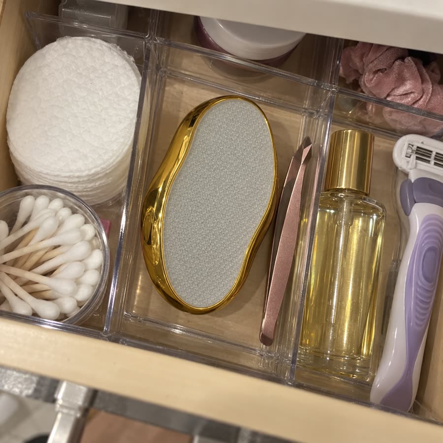 Gold crystal hair eraser organized in a bathroom drawer with beauty tools