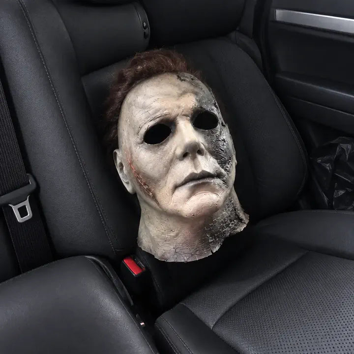 Halloween horror mask resting on car seat