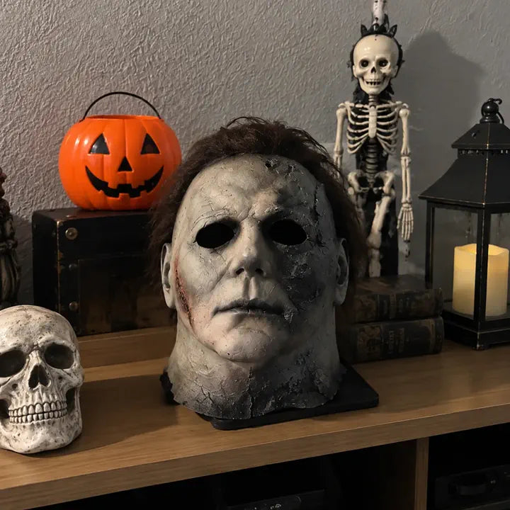Halloween horror mask displayed with pumpkin decor