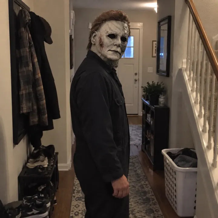 Full costume wearing Halloween horror mask in hallway