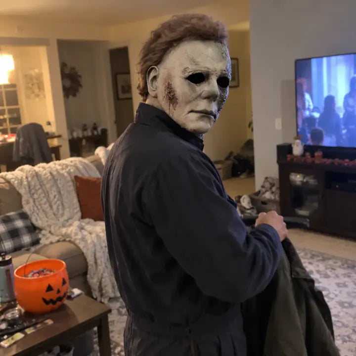 Customer wearing Halloween horror mask in living room