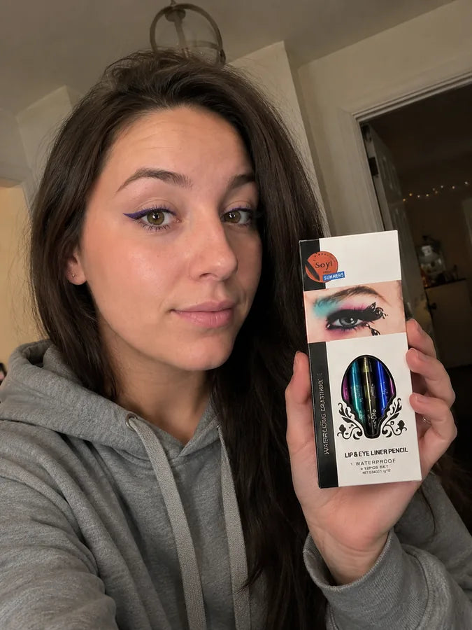Customer holding the lip and eye liner pencil set while wearing purple eyeliner