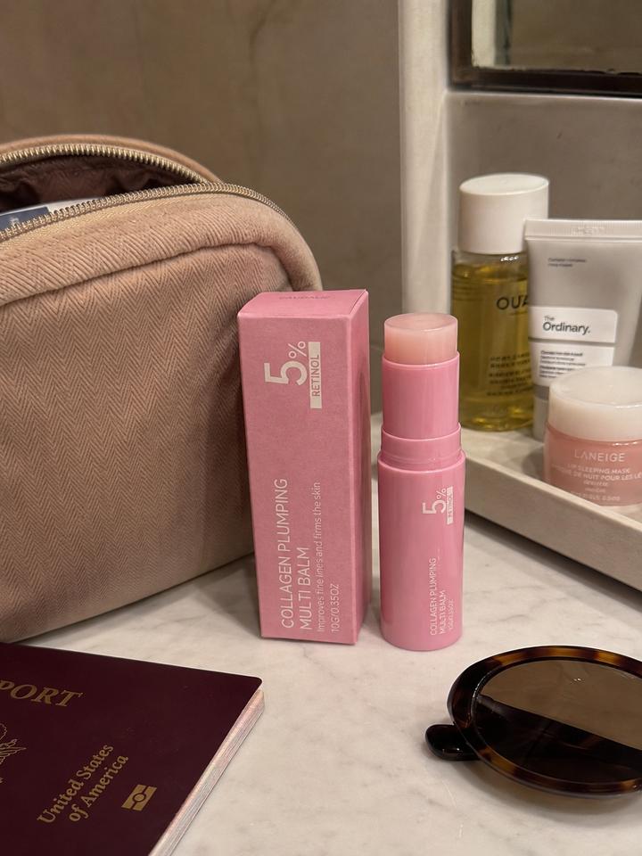 Customer review photo showing PDRN multi balm packed for travel with skincare essentials